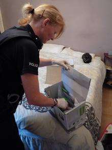 PC Ann Jeffrey searches the property during the warrant