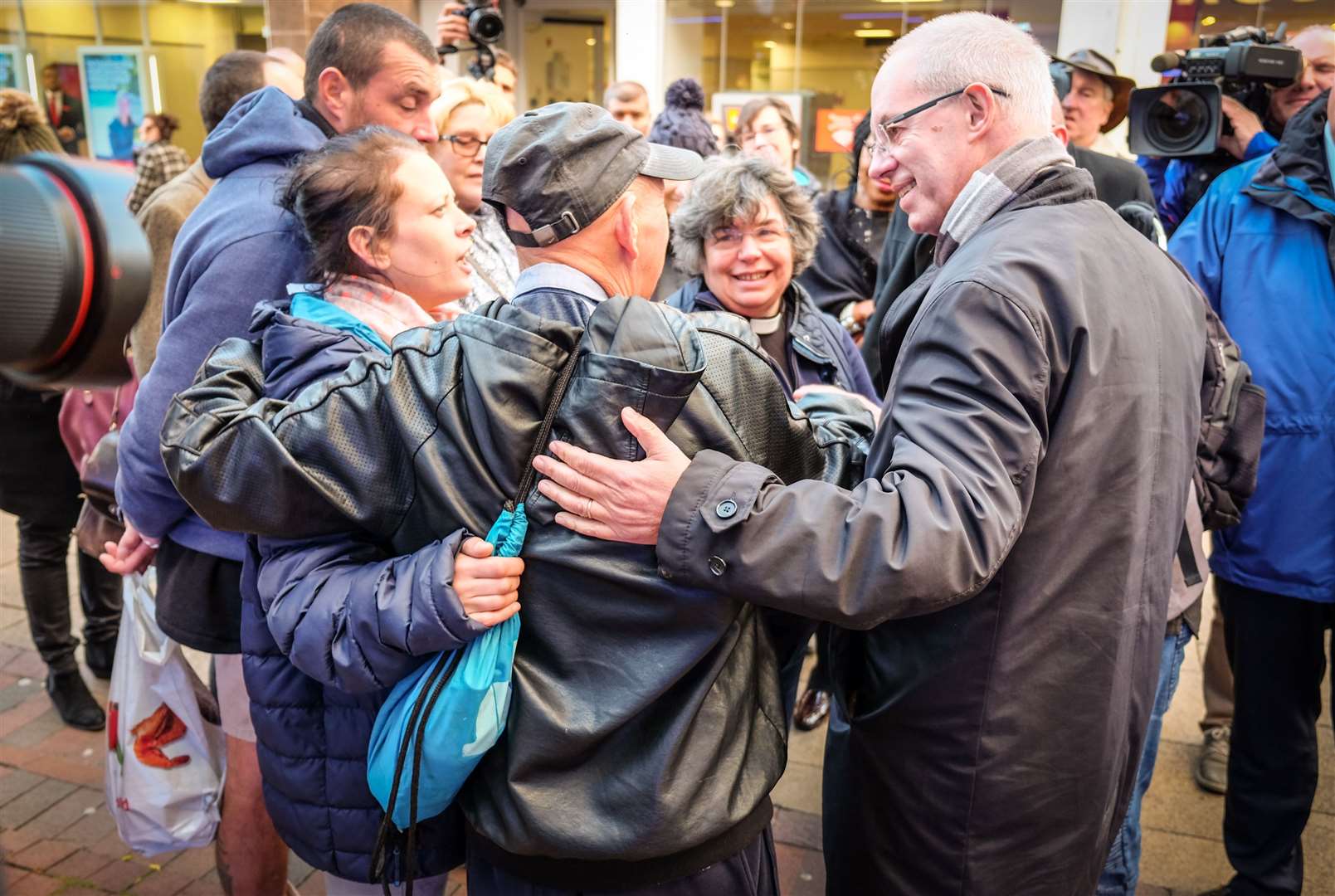 Archbishop of Canterbury's prayer walk in Chatham High Street. Archbishop Justin Welby says a prayer outside a bookmakers and is shown love by some locals. Picture: Matthew Walker. (15785926)