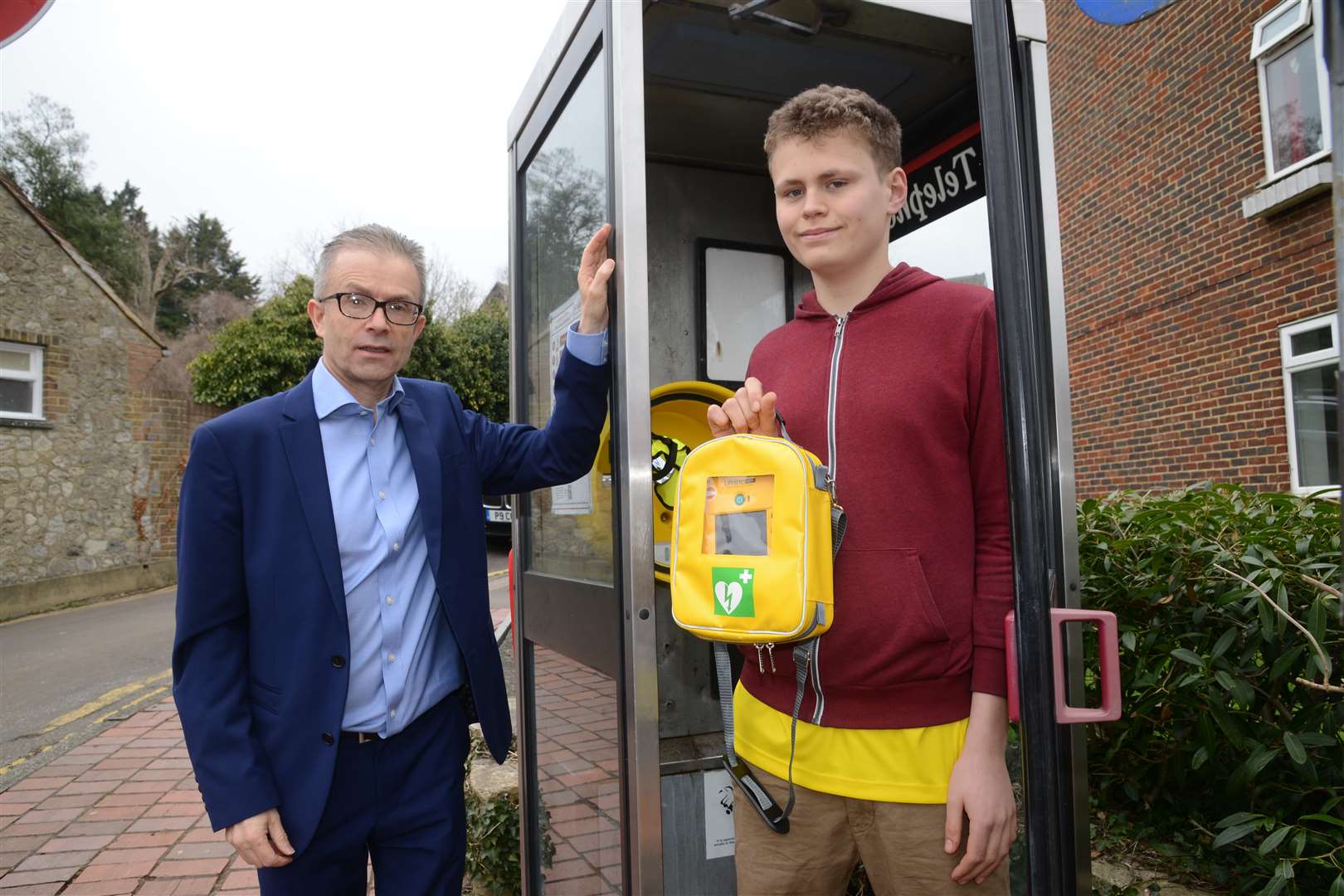 Cllr Trevor Walker and Archie Mitchell, 15 unveiling the new defibrillator fitted in the old phone box.Aylesford village centre.Picture: Gary Browne (1279933)