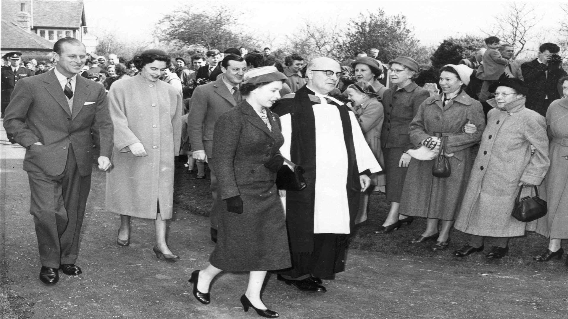 Crowds lined the church approach on April 5 1957 as Her Majesty The Queen and Prince Phillip joined Lord and Lady Brabourne for a service conducted by Rector, the Rev H McDonald at Mersham Parish church. Picture: "Images of Ashford" book by Mike Bennett