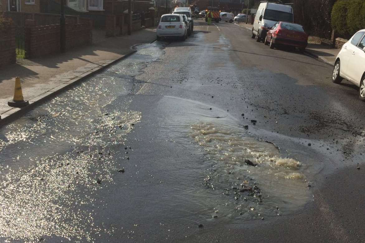 Water gushes along the street in Mickleburgh Hill