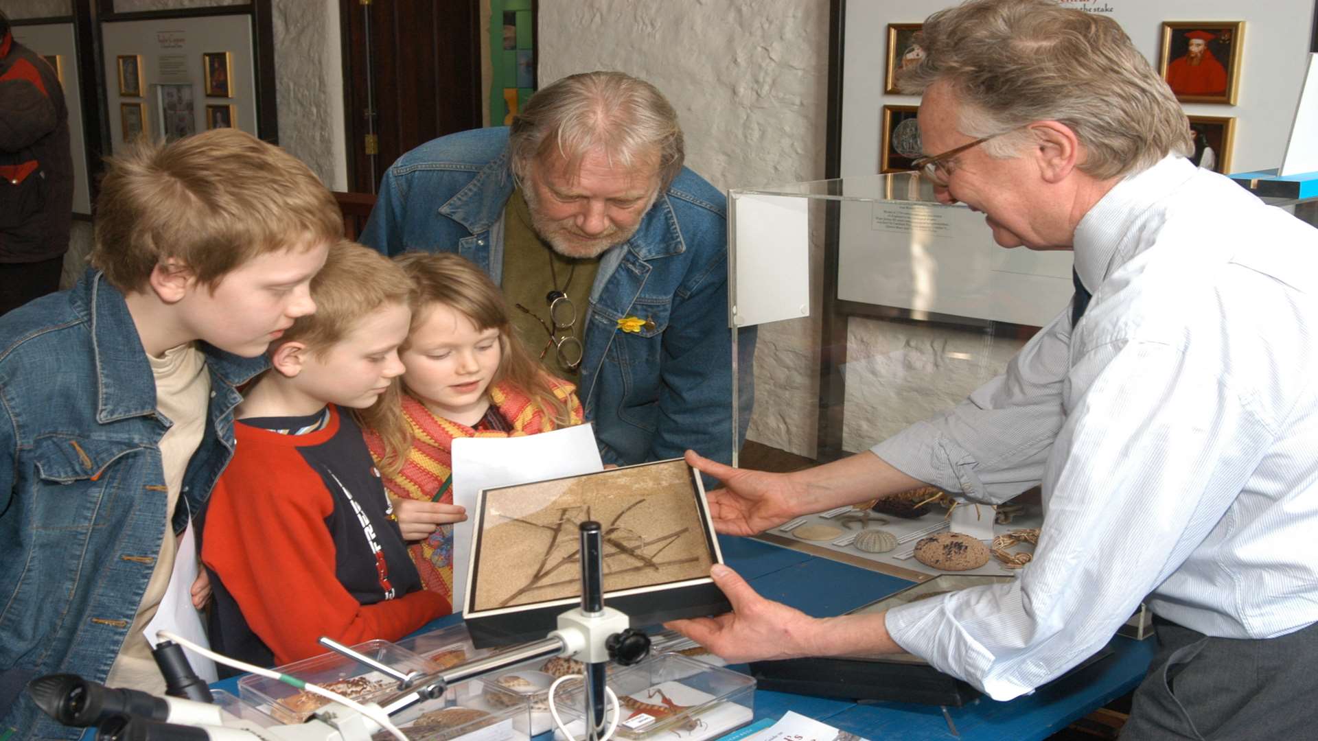 Julian Spurrier showing a stick insect to visitors at Canterbury Heritage Museum
