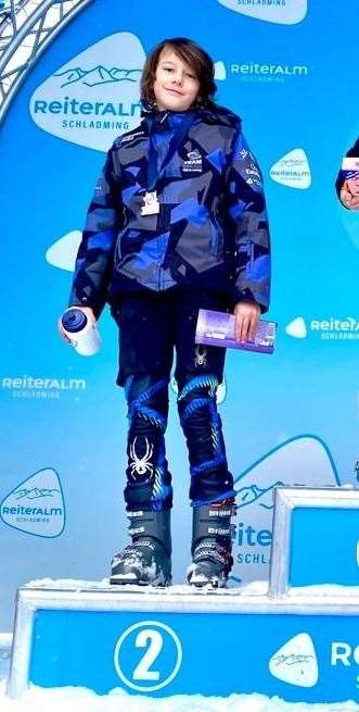 Austin Scott, from Tenterden, on the podium in Austria after finishing second in the giant slalom.