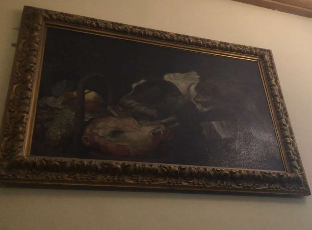 The painting which shows a greyhound sniffing at what looks like an oxe's head