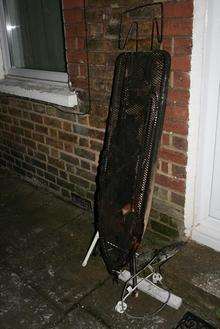 Ironing board and iron outside house which caught alight in Eastgate Terrace, Rochester