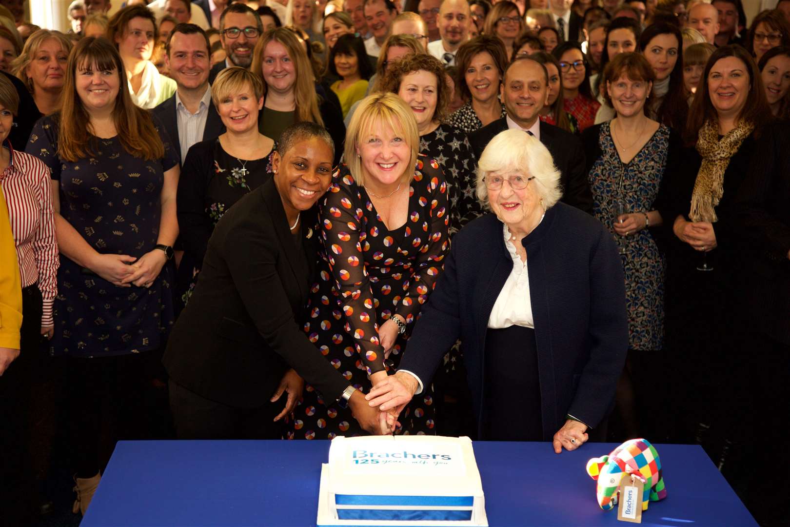 From left: Guest Stephanie Boyce (deputy vice-president of the Law Society), managing partner Joanna Worby and Sarah Bracher (wife of late George Bracher) cut a cake to mark the firm's 125th anniversary