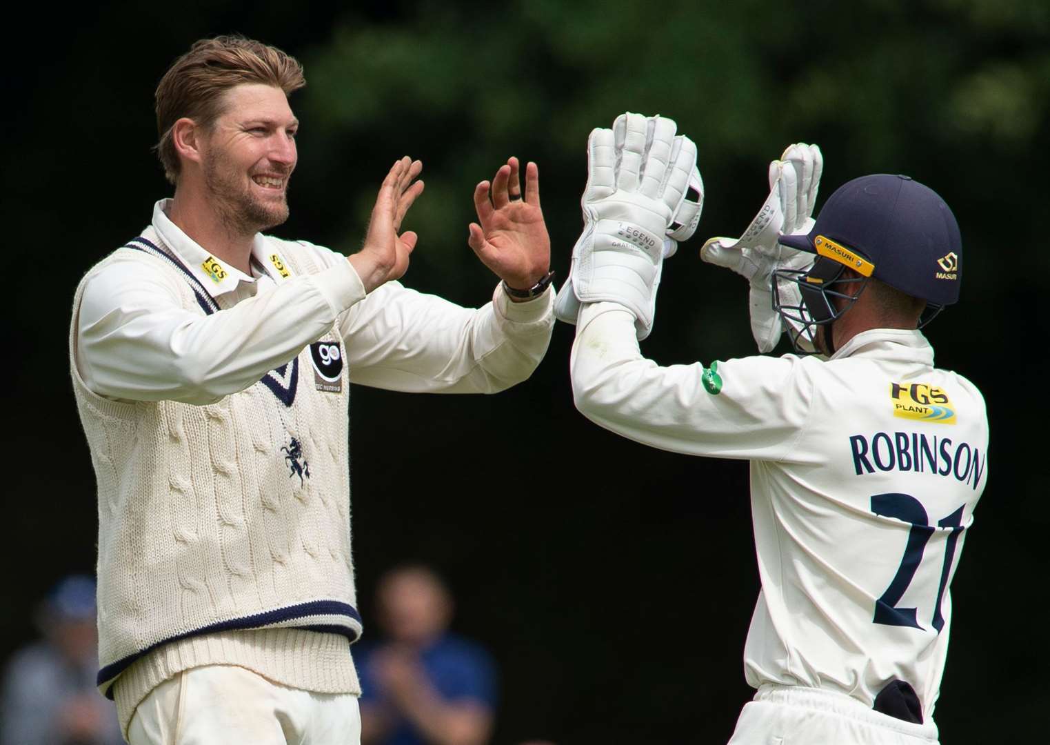 Kent's Ollie Rayner celebrates his second wicket with Oli Robinson. Picture: Ady Kerry
