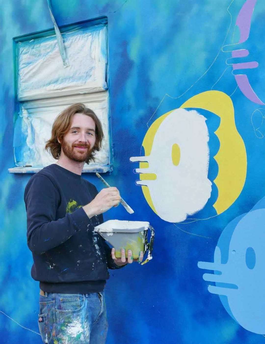 Jordant Grey working on his mural in Clifton Gardens. Picture: Frank Leppard