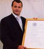 Steve Holmes accepts a Queen's Award in 2004