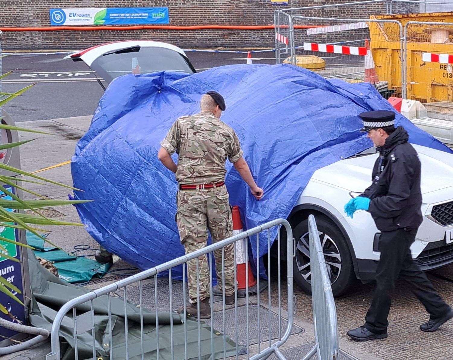 Soldiers and police examine a car inside the Limekiln garage Photo: Sam Lennon (60308180)