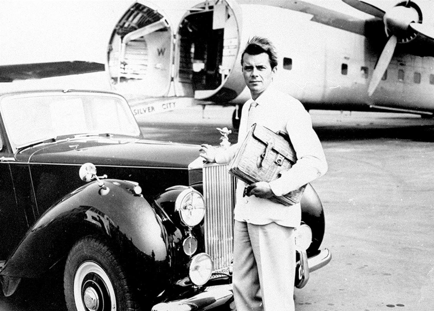 Dirk Bogarde - English actor and writer - taken to the tarmac of his limousine