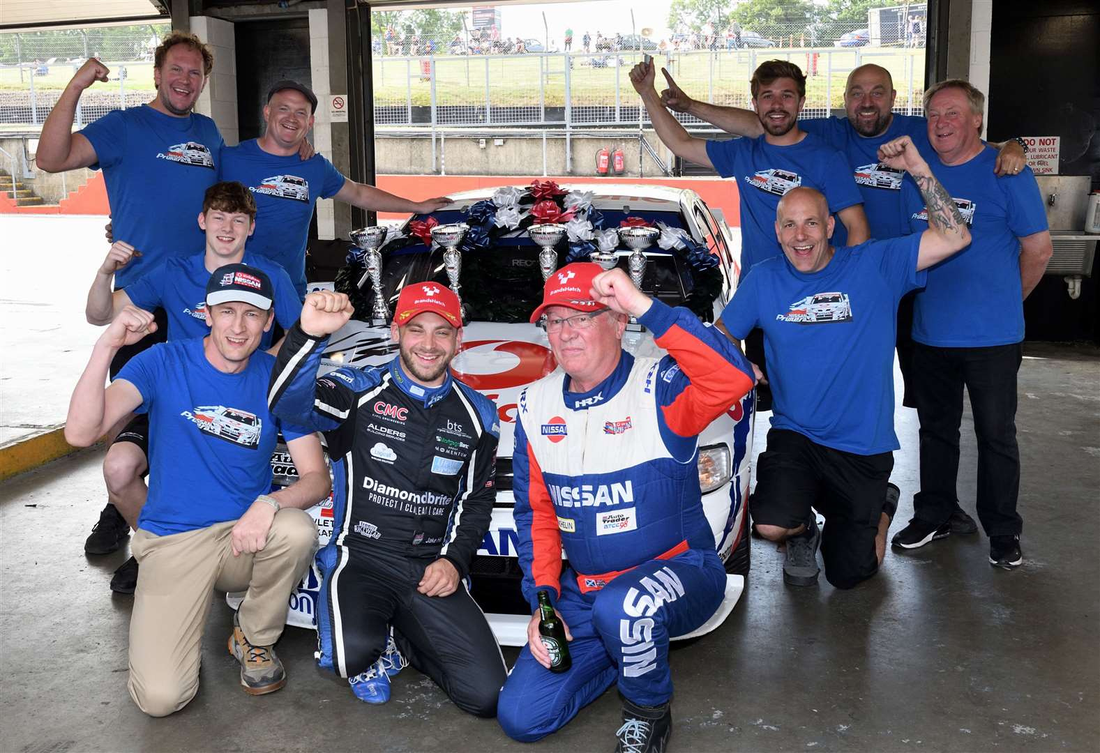 Hill celebrating with Richard Wheeler, former BTCC star Anthony Reid and the rest of the John Danby Racing crew. Picture: Simon Hildrew
