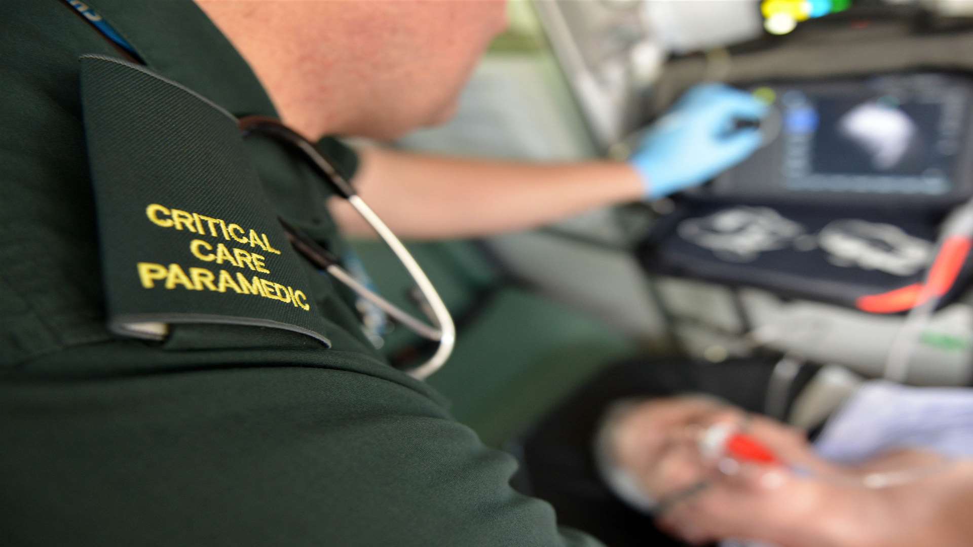 Paramedics help a patient in the back of an ambulance. Stock image