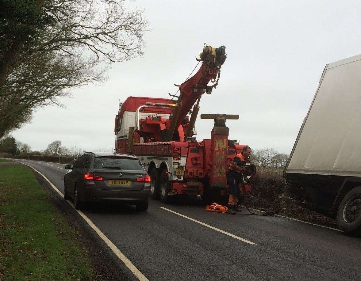 An articulated lorry being recovered after it veered off the road near Biddenden