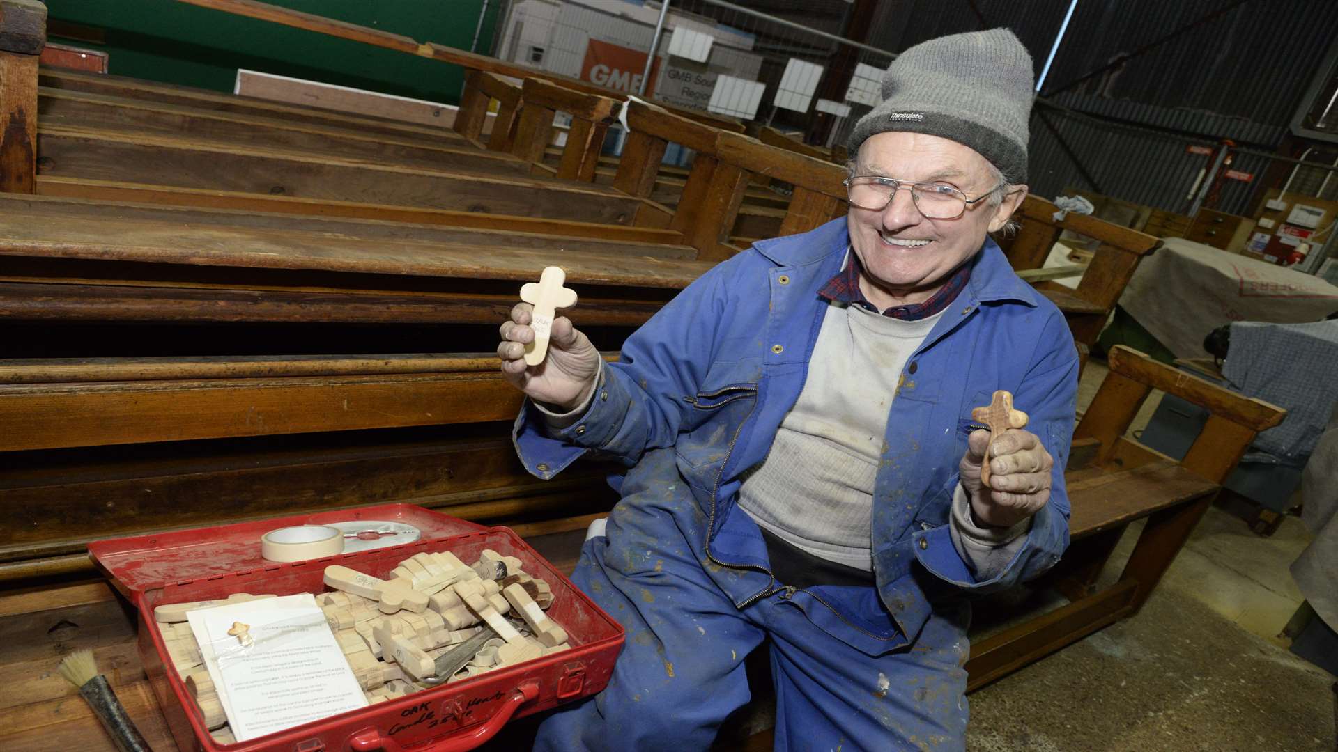 Brian with the crosses made for the church which has donated the pews to be made into seats
