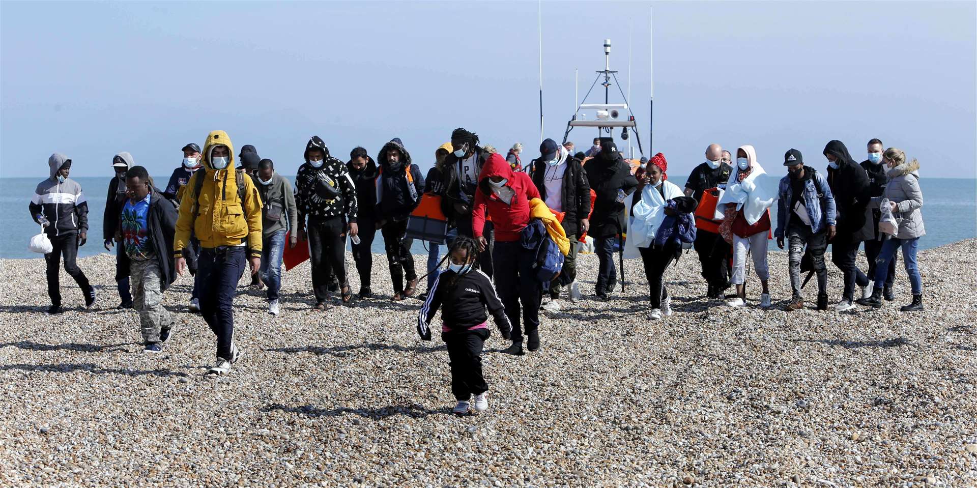 Asylum seekers arrive at Dungeness beach after being rescued at sea by the RNLI. Picture: Sean Aidan