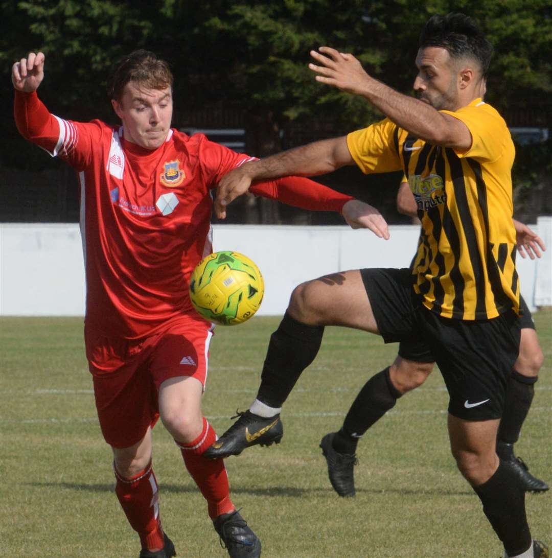 Folkestone Invicta's Kieron McCann, right, puts in a challenge against Whitstable on Saturday Picture: Chris Davey