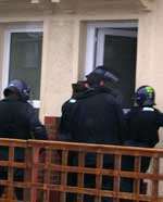 Police descend on a house in Gravesend on Thursday