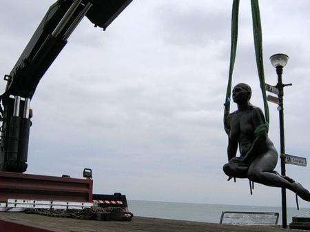 The Folkestone Mermaid is lowered into position at the harbour