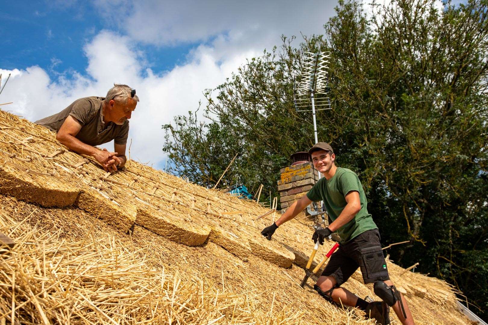 Glen and Rich, of Glen Charter Master Thatchers, working on an old cottage in Newnham. Pic: Tony Gostling