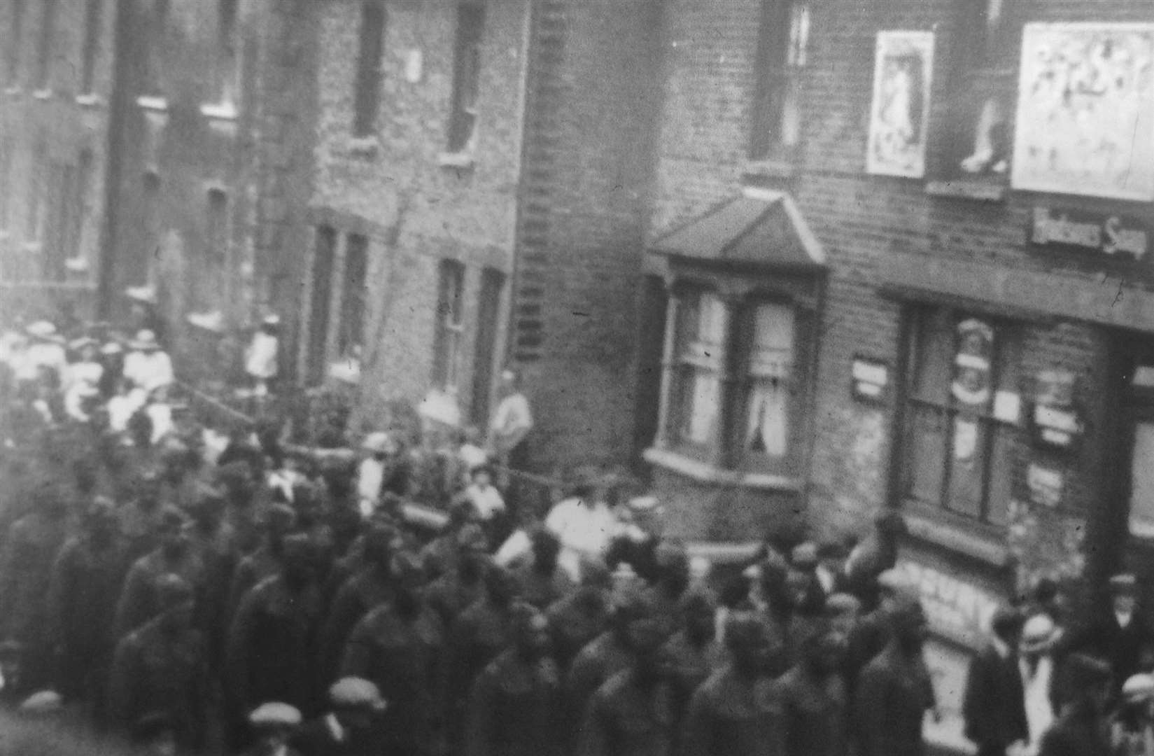 A group of 58 African American soldiers walk through Swanscombe in Milton Road, 1918