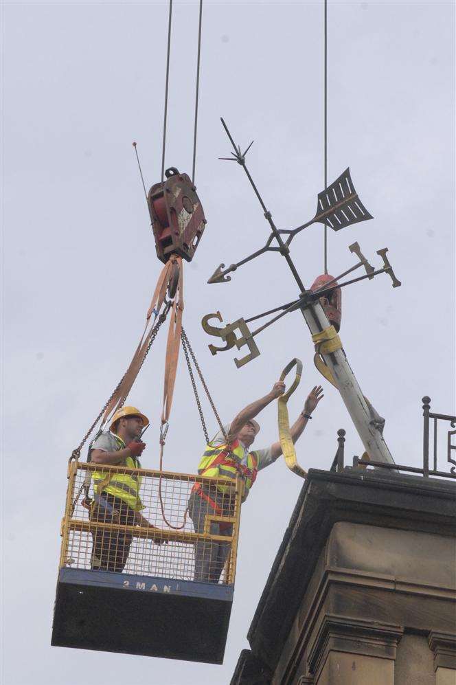 Ben Coulson, of Liftec, and Peter Marchington, of Powerlift, attach straps to the weather vane