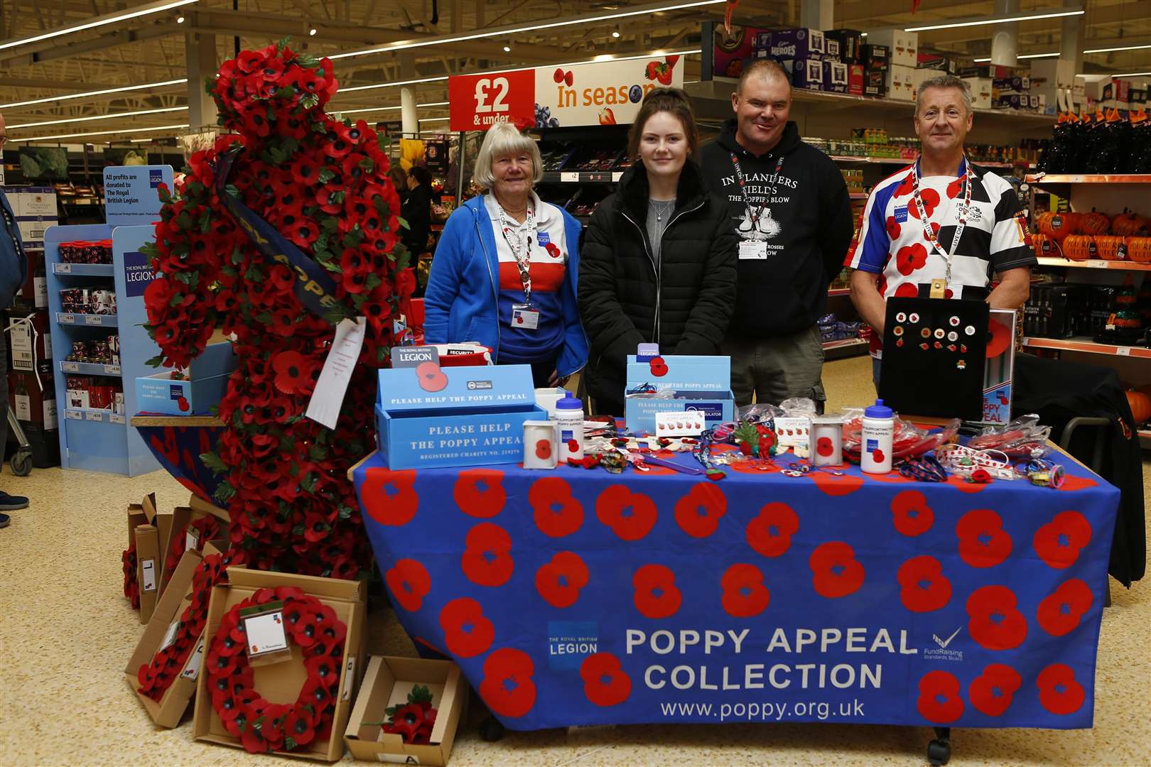 Doris Taylor, Katie Taylor, Dave Taylor & Michael Terry inside the store with their Poppy Appeal stand.