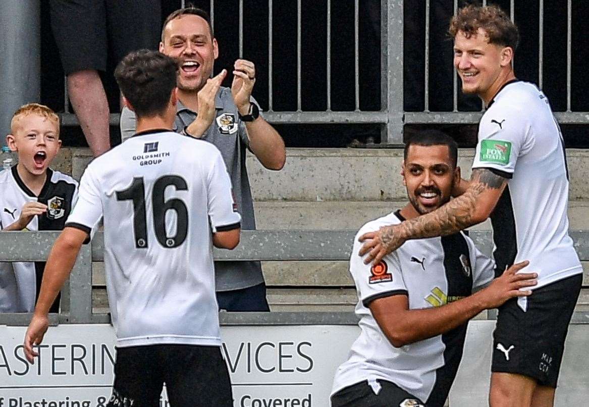 Two-goal Lewis Manor is congratulated by team-mates Baris Altintop and Archie Woods but his brace proved in vain in Dartford’s 3-2 derby defeat at home to Welling in the FA Cup. Picture: Dave Budden