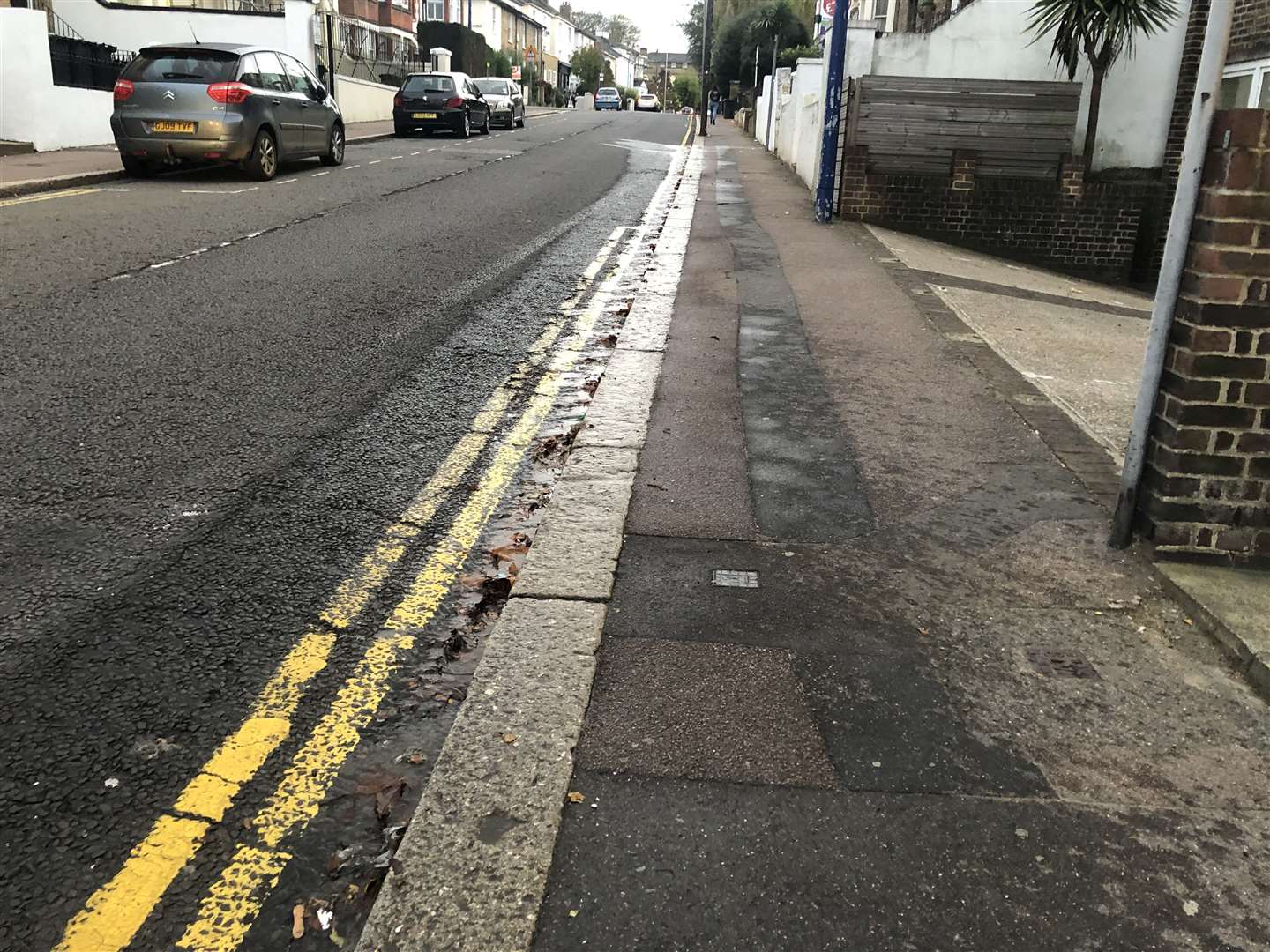 The water is running down the side of the kerb