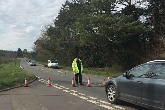 Police closed the A252 after the car and bike were involved in a crash.