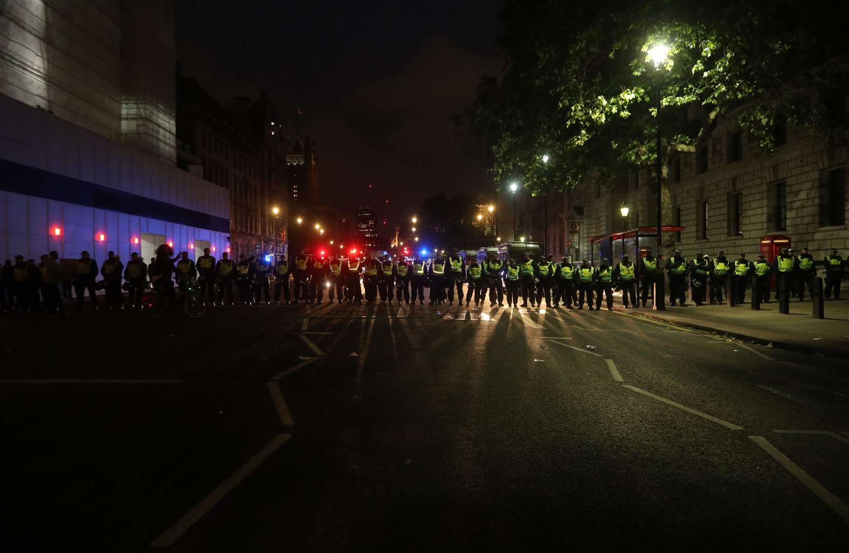 Police officers line the street on Whitehall (Yui Mok/PA)
