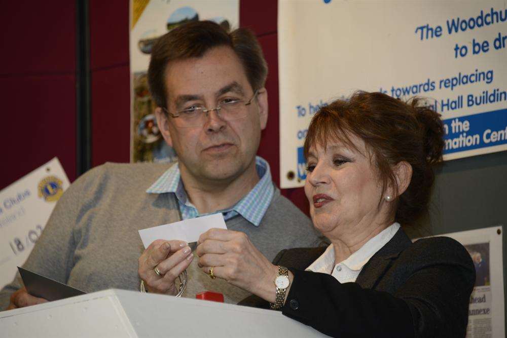 Actress Jan Francis draws the tickets for the Woodchurch Memorial Hall annexe raffle, with the help of organiser Nick Jones