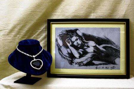 The Heart of the Ocean necklace worn by Kate Winslet in the 2007 film Titanic along with the drawing of her by director James Cameron