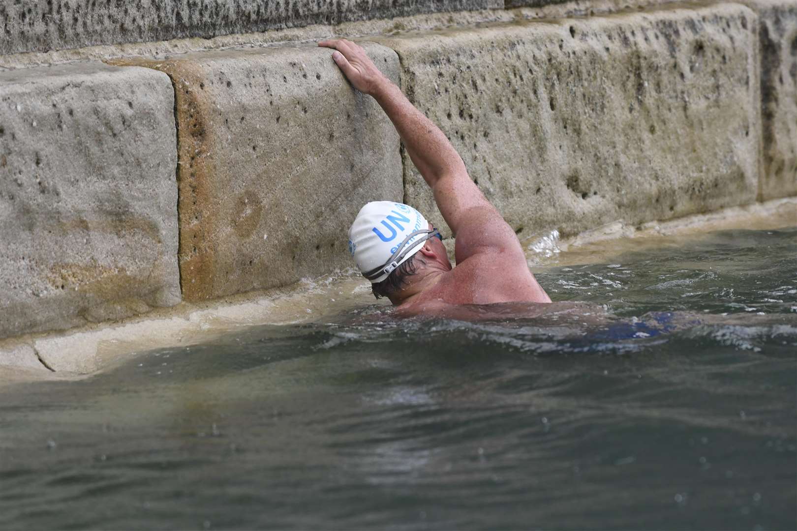 Got there - Mr Pugh touches the harbour wall as his swim ends..Picture: Tony Flashman