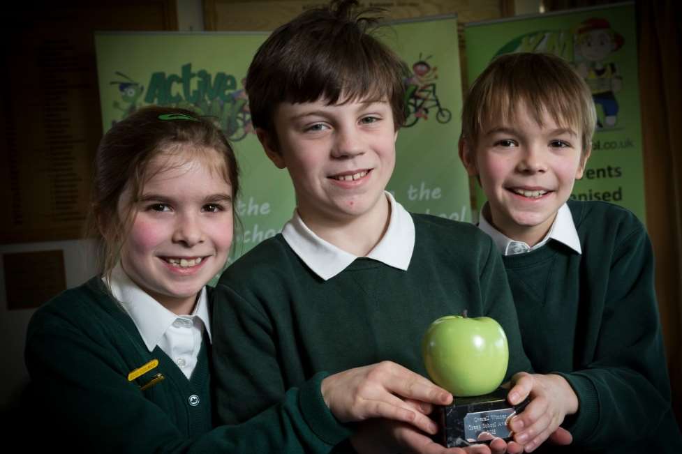 Pupils from Sutton Valence Primary School hold up their special Green Apple trophy for being crowned Overall Nature Conservation Champion at the Green School Awards 2018.