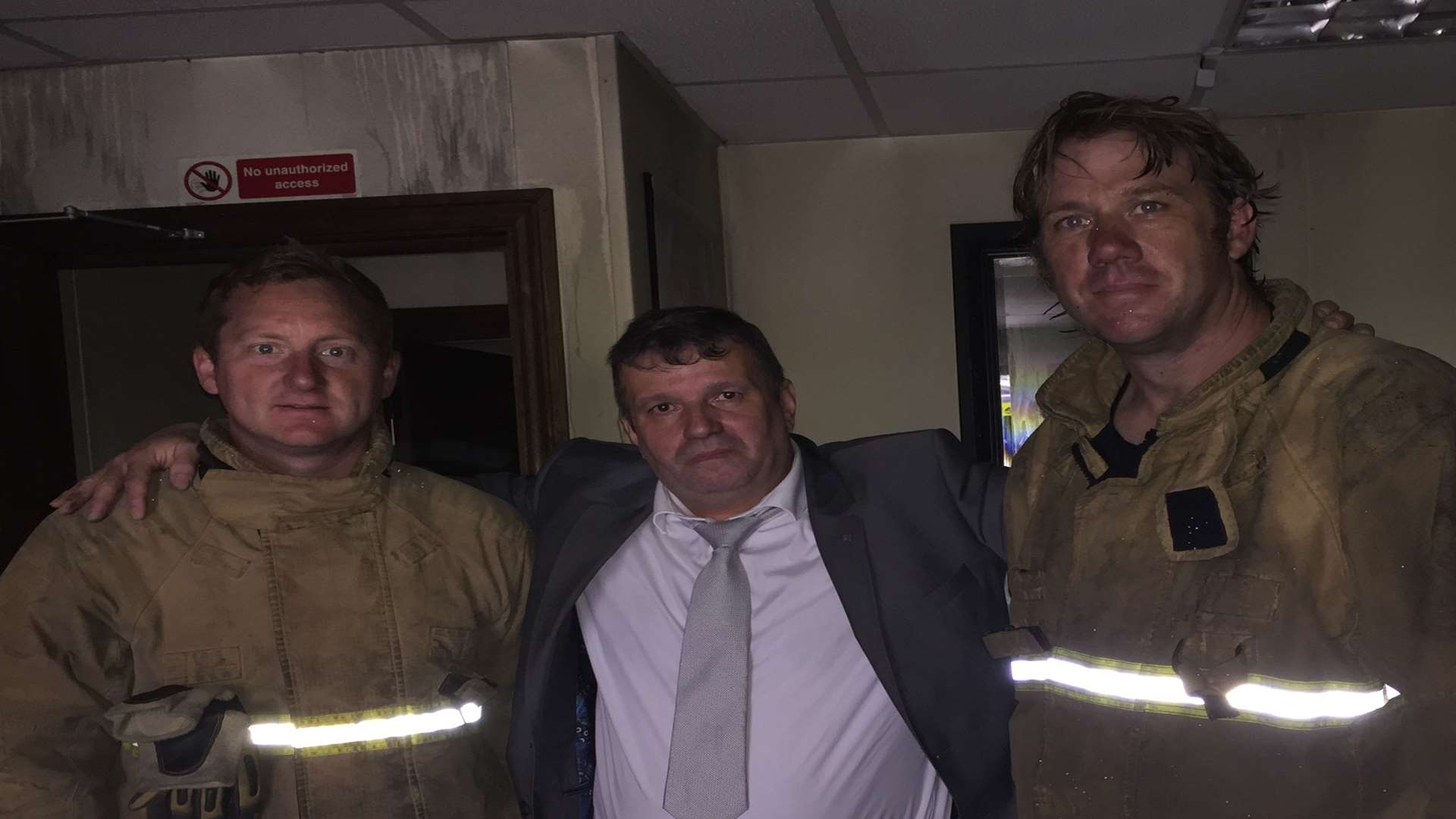 Mazen Khader thanks two of the firefighters who saved his shop