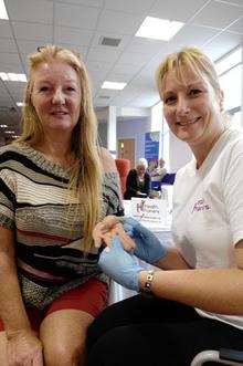Helen Hopwood has a cholesterol check by Health Trainer Nicola Reynolds during the NHS beats and Breathes campaign held in the Sheerness Gateway Centre