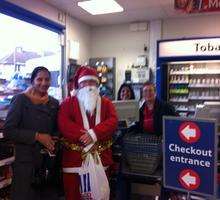 Santa poses with staff and customers at a petrol station in Medway