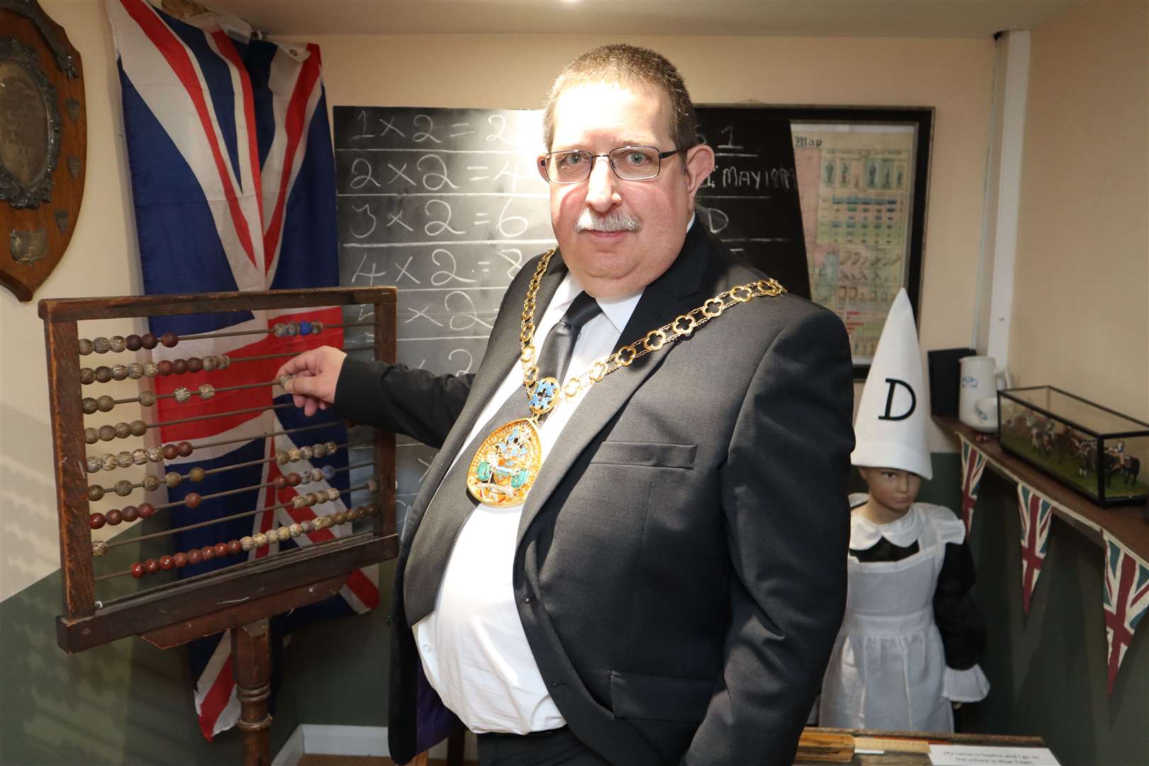 Swale mayor Simon Clark goes back to school at the Criterion Theatre and Blue Town Heritage Centre. The classroom has an abacus counting frame, chalk blackboard, desks and a dunce's hat