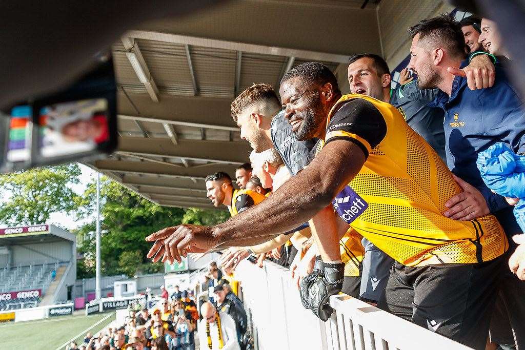 George Elokobi joins in the title celebrations Picture: Helen Cooper