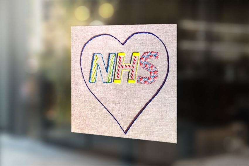 Lucy Martin’s completed NHS embroidered heart hanging in a window