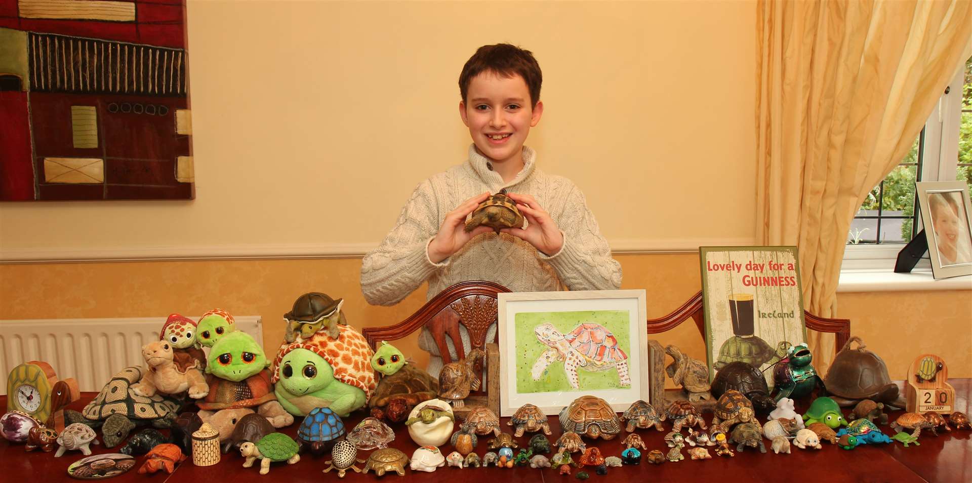 Cameron with his pet tortoise and some of his collection