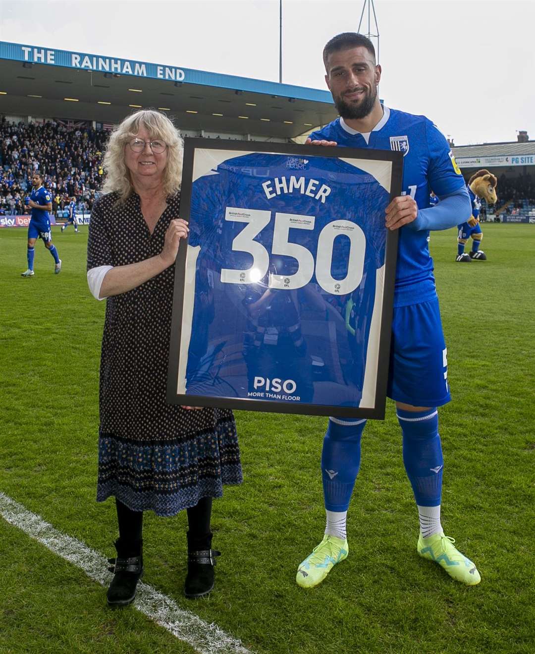 Max Ehmer, who signed a new deal at the end of last week, receives a commemorative shirt marking 350 appearances for Gillingham.