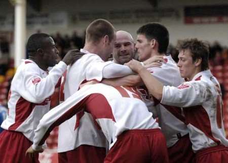 Tommy Mooney (third right) is mobbed after scoring Walsall's opening goal. Picture: ANDY PAYTON