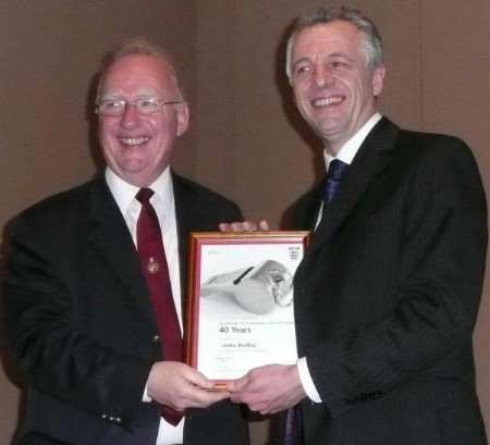 John Roffey, left, receives a certificate to mark his 40 years as a referee from Ed Stone, of the Football Association