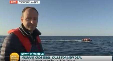 Reporter Jonathan Swain and the boat behind him. Picture credit: Good Morning Britain