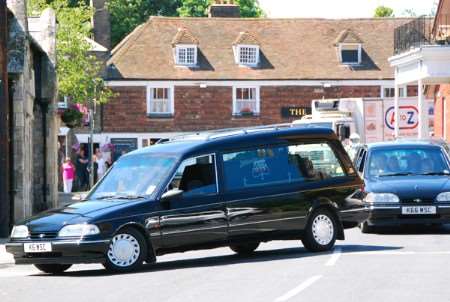 The hearse carrying Det Con Andy Eley's coffin arrives at St Mary's church in Minster