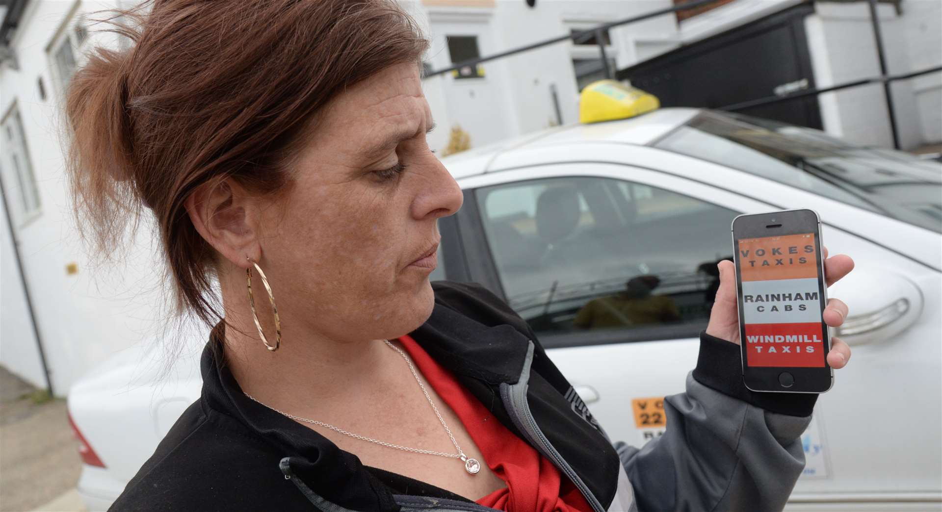 Marie Greenwood demonstrates the new app for Vokes Taxis in Chatham. Picture: Chris Davey (14165336)