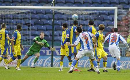 Alan Julian dives to save a Huddersfield free-kick