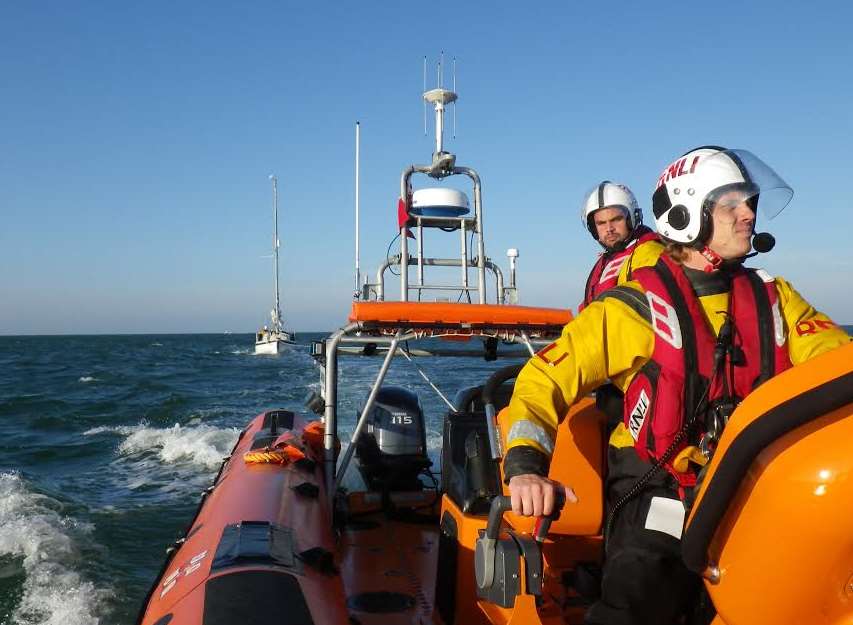 Lifeboat helmsman Dan Sinclair and volunteer towing the yacht to safety